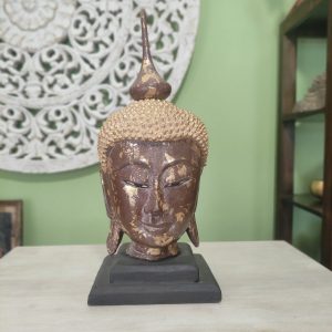 scultura testa di buddha in legno con foglia d'oro