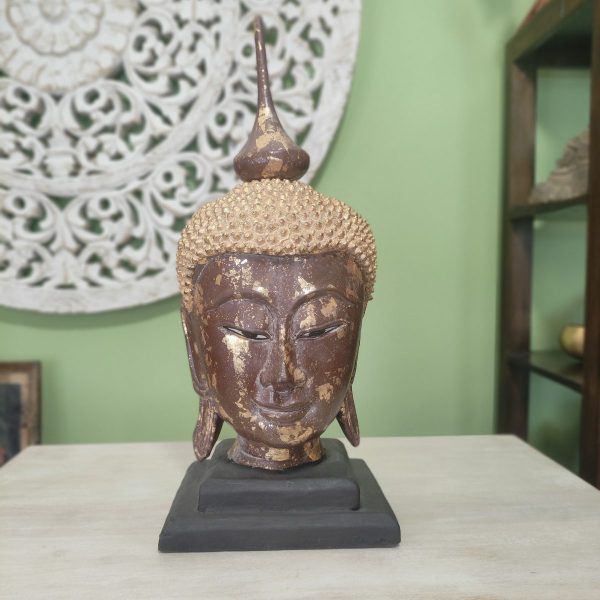 scultura testa di buddha in legno con foglia d'oro