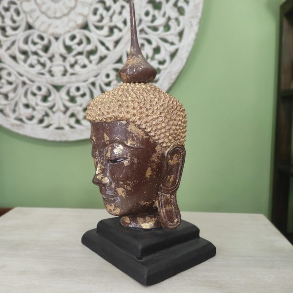 scultura testa di buddha in legno con foglia d'oro