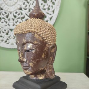 scultura testa di buddha in legno con foglia d'oro