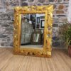 Specchio con cornice oro in legno intagliato