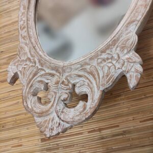 dettaglio dell'intaglio di specchio in legno sbiancato ovale
